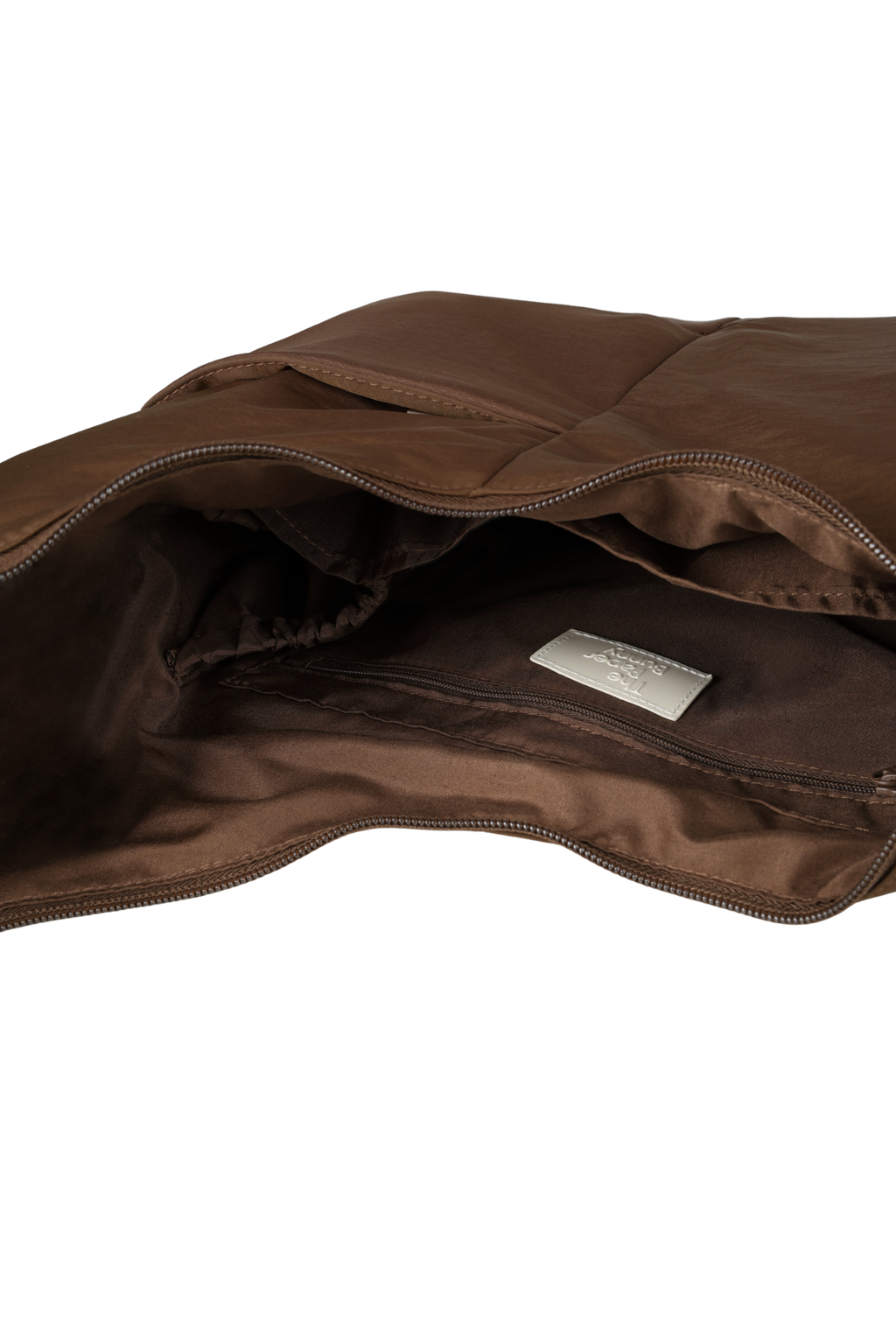 Interior of the Midi Arc hobo-style bag in chocolate brown nylon, with multiple pockets and a bottle holder